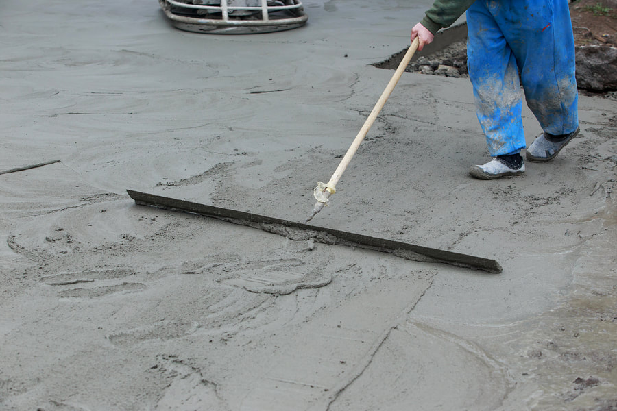 man doing concrete flooring